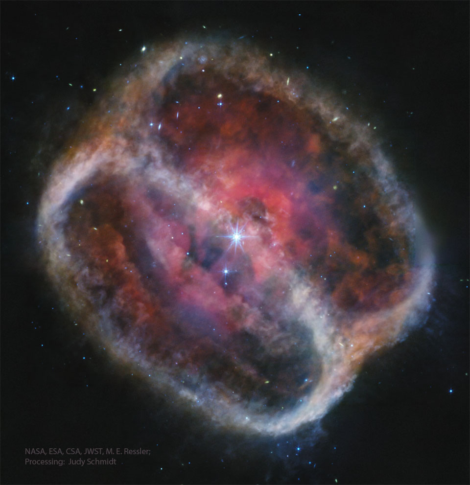 A starfield is dominated by a multi-colored figure
8 in the middle, titled on a diagonal. The outsides 
of the nebula appear light colored, while the inside shows
complex structure tinted red and purple. 
Please see the explanation for more detailed information.